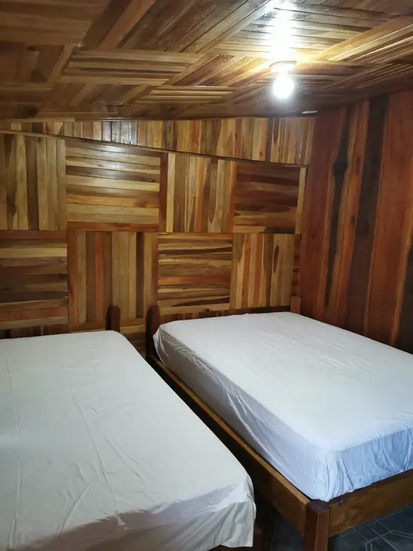 Bedroom with wood-paneled walls