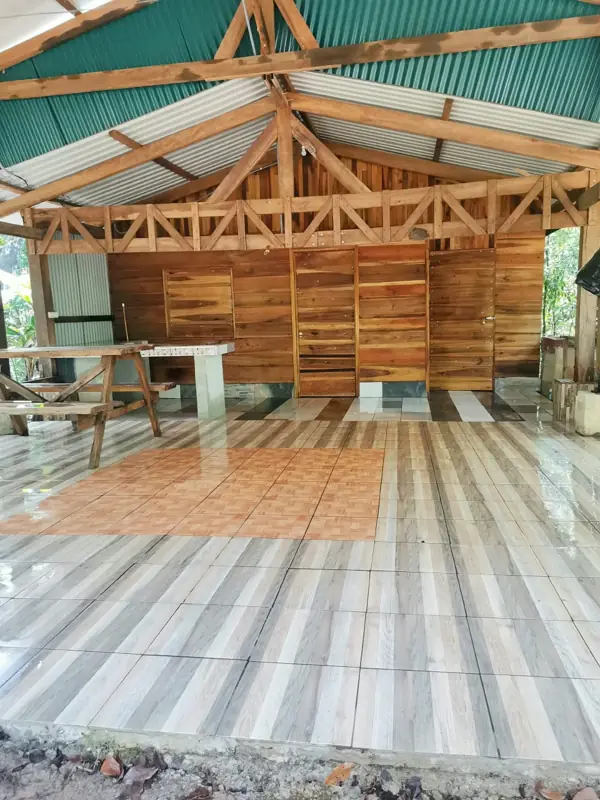 Second cabin: open kitchen and dining area under a timber roof