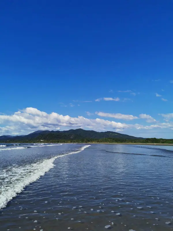Wide beach with mountains behind